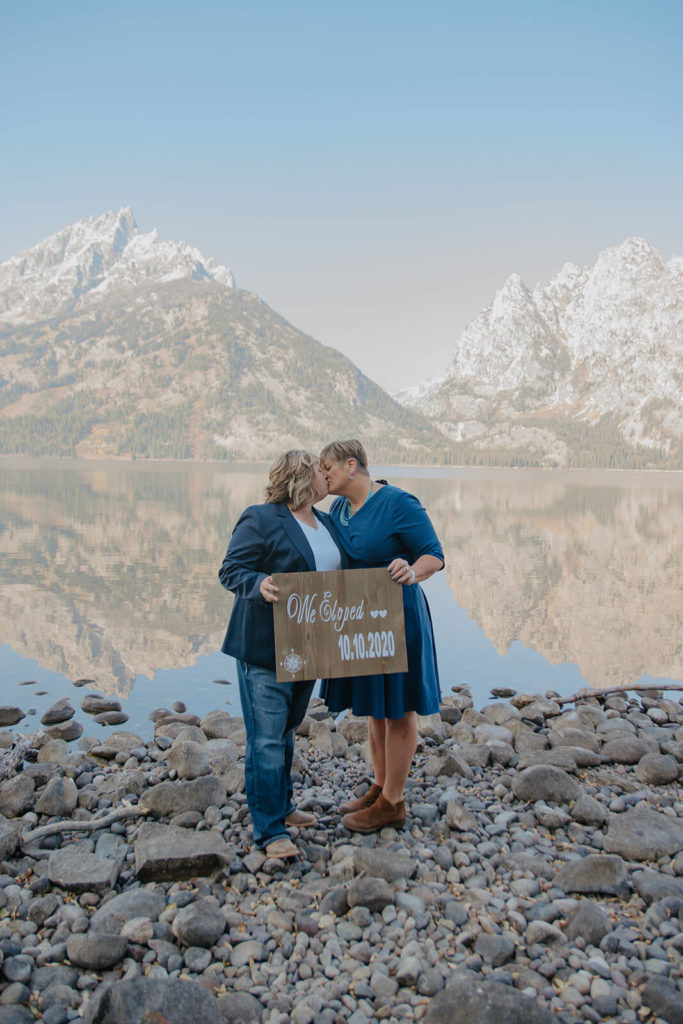 Elopement Announcement with Couple Kissing Mountain Background