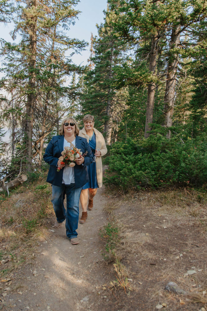 Beth and Haley Walk Together During Destination Elopement in Jackson Hole