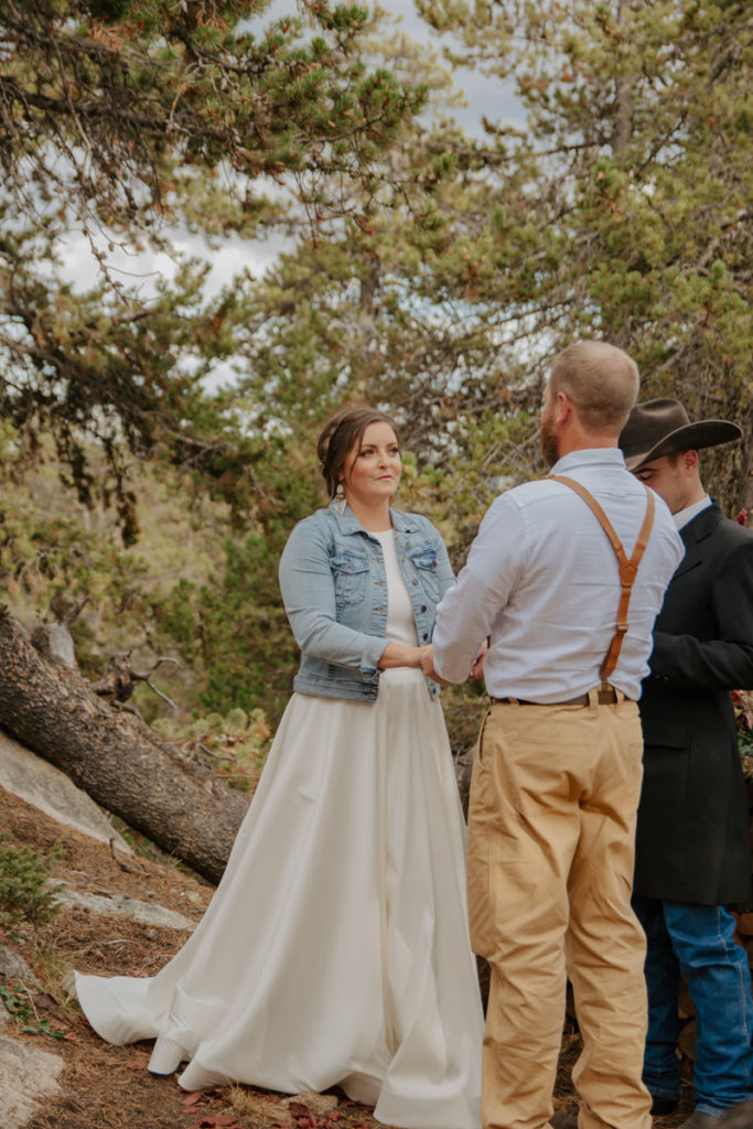 Bride Looks at Groom During Elopement Ceremony in Wyoming