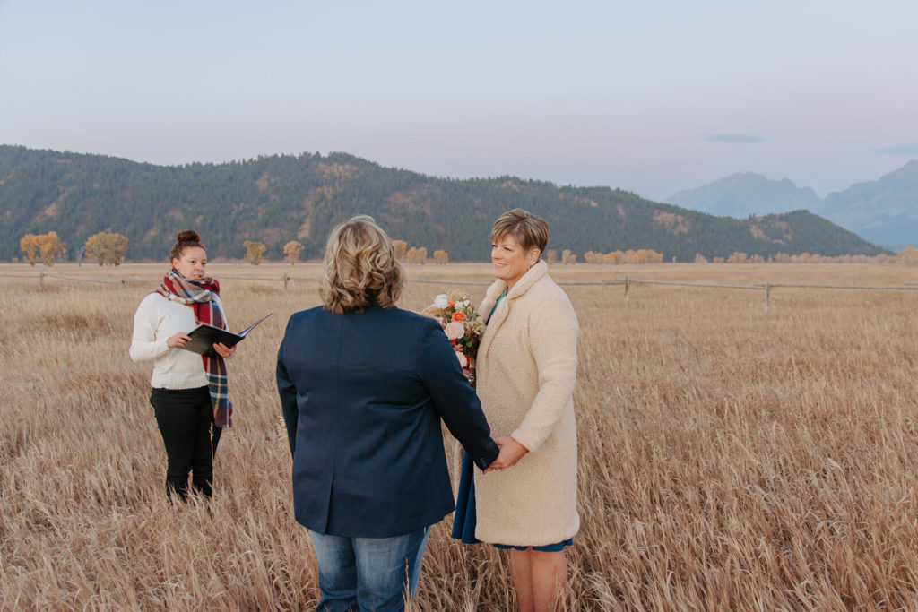 Couple Holds Hands During Elopement Ceremony in Jackson Wyoming