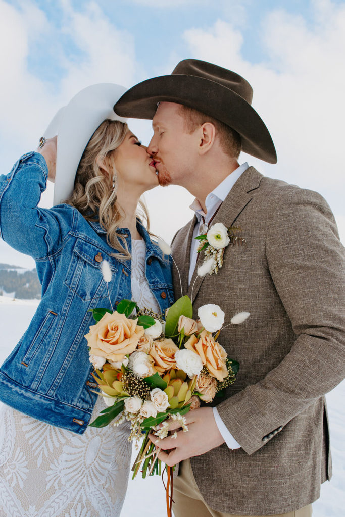 Groom Kisses Bride During Winter Wedding in Wyoming