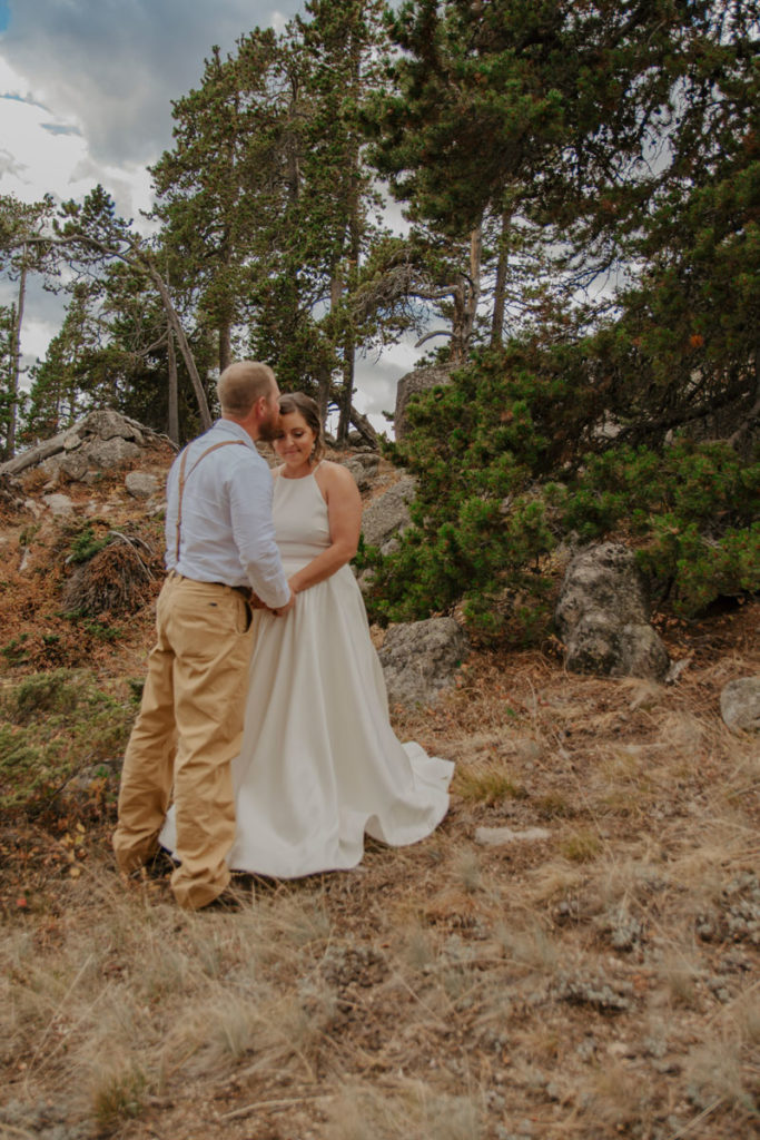 Bride and Groom Cuddle after Outdoor Elopement