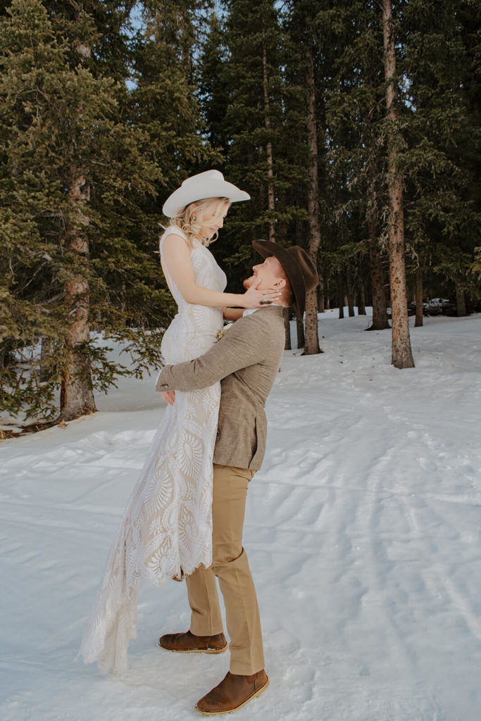 Groom Lifts Bride During Wyoming Winter Elopement