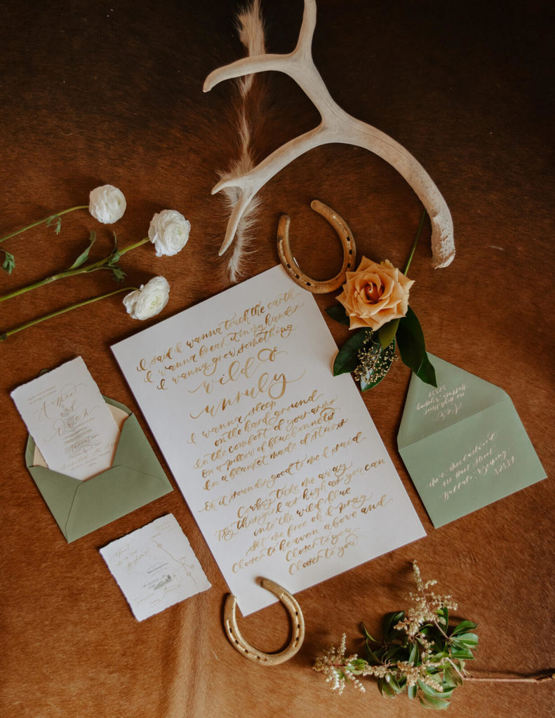 full shot of invitations for winter wedding in wyoming