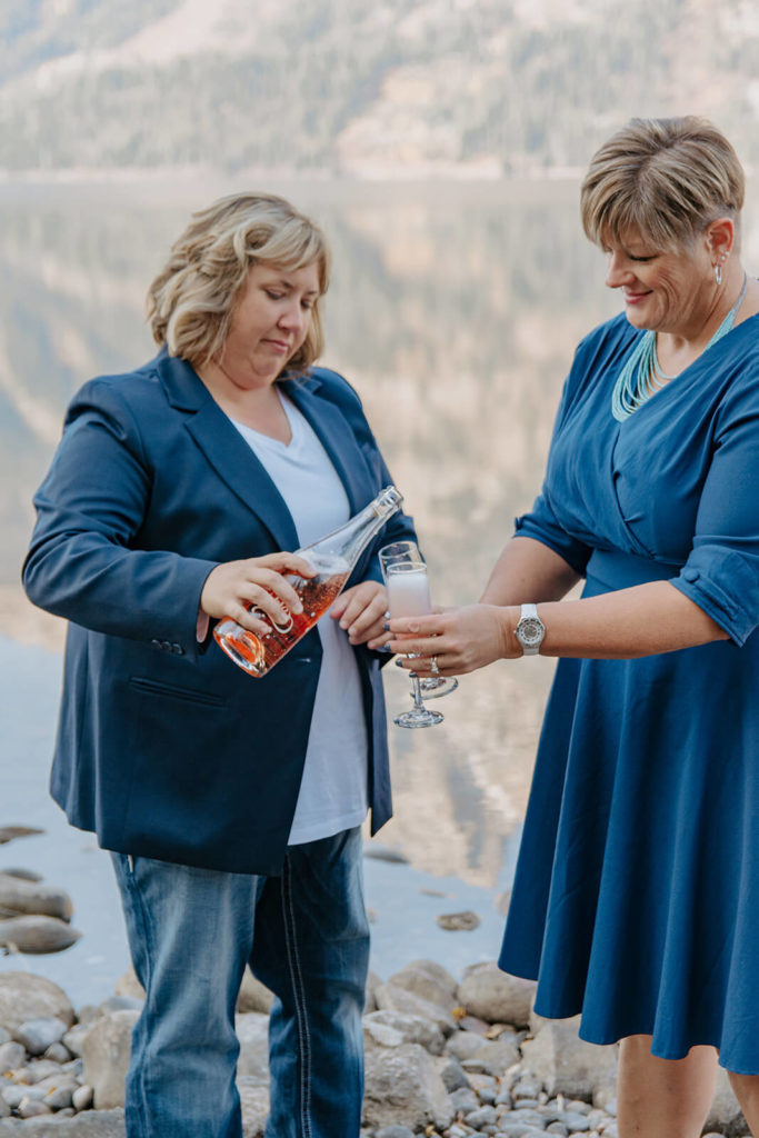 Partner Pouring Wine During Destination Elopement in Tetons