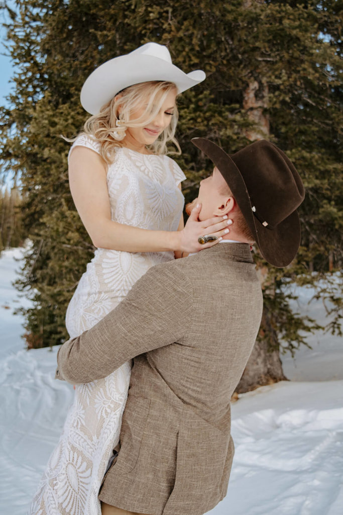 Groom Lifts Bride at Winter Wedding in Wyoming