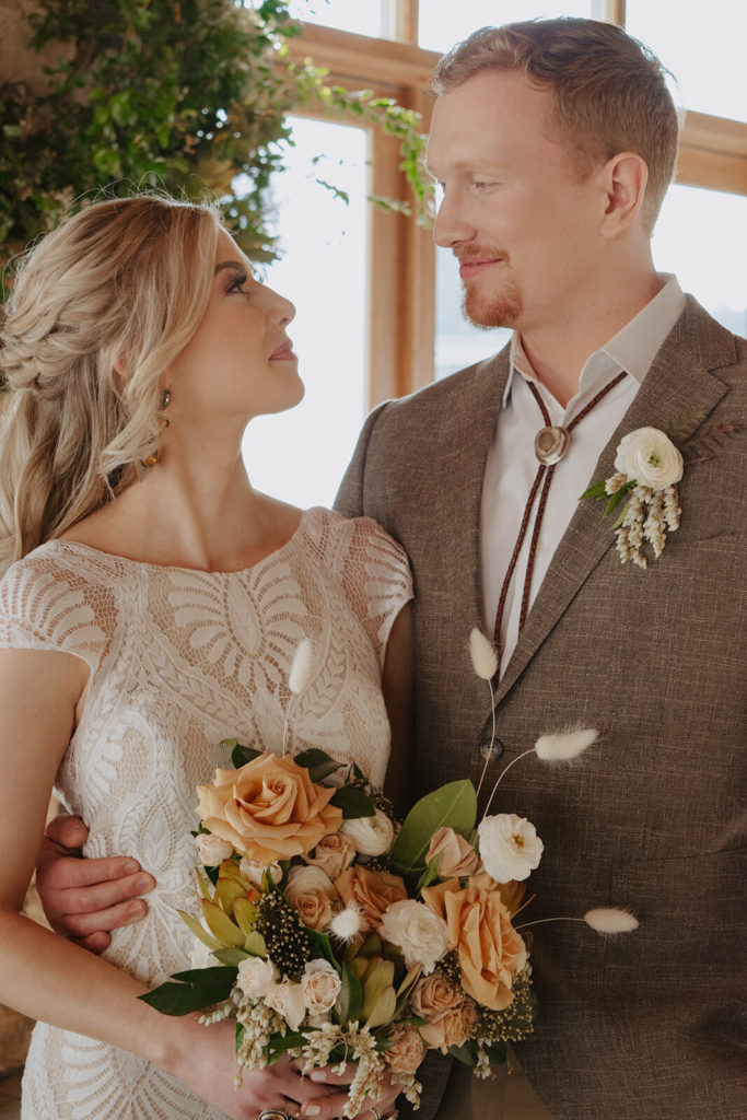 couple gaze at each other during rustic winter wedding