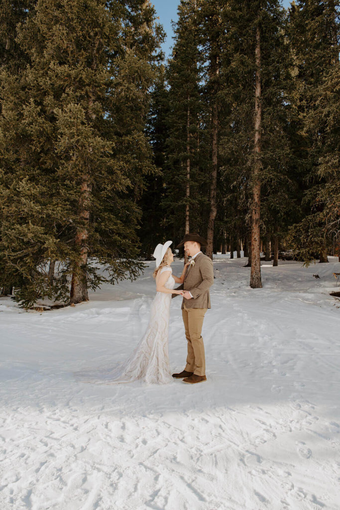 Bride and Groom Among Pine Trees During Wyoming Winter Elopement