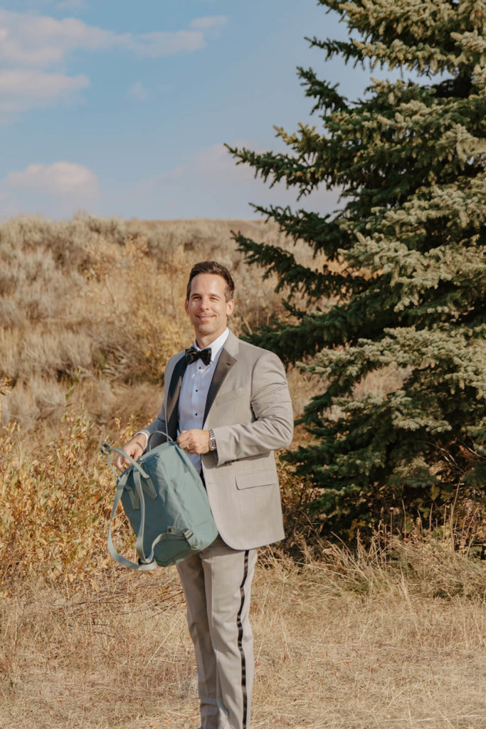 Clay Carries Hiking Bag after Ceremony