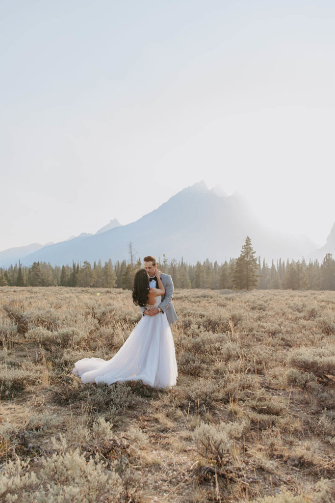 Couple Kissing with Teton Mountains in Background