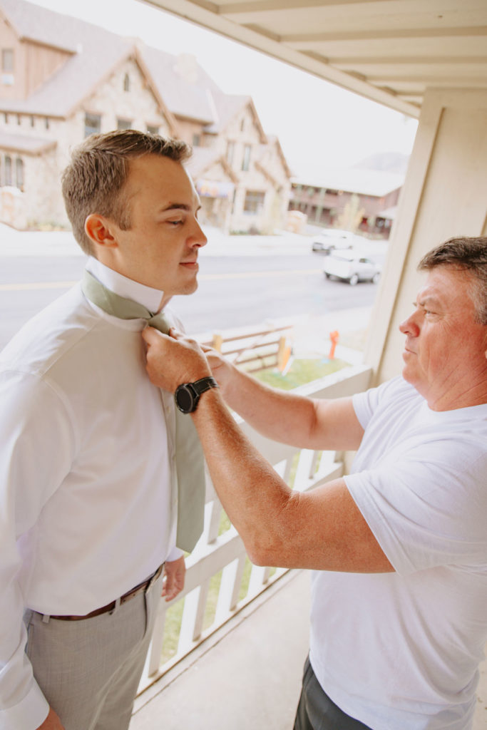 Father Helps Groom With Tie