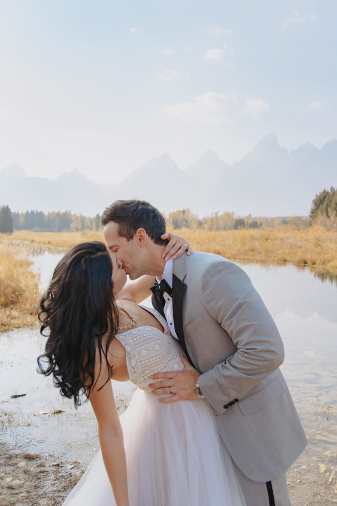 Rachel and Clay Kiss with Teton Mountains in Background