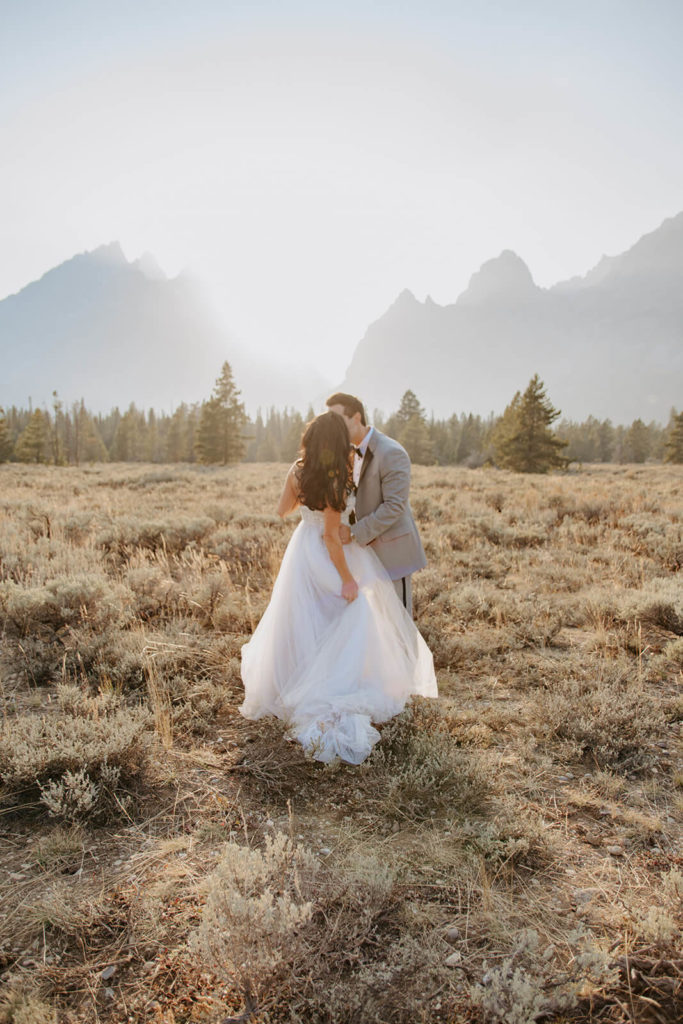 Rachel and Clay Kiss with Mountains in Background