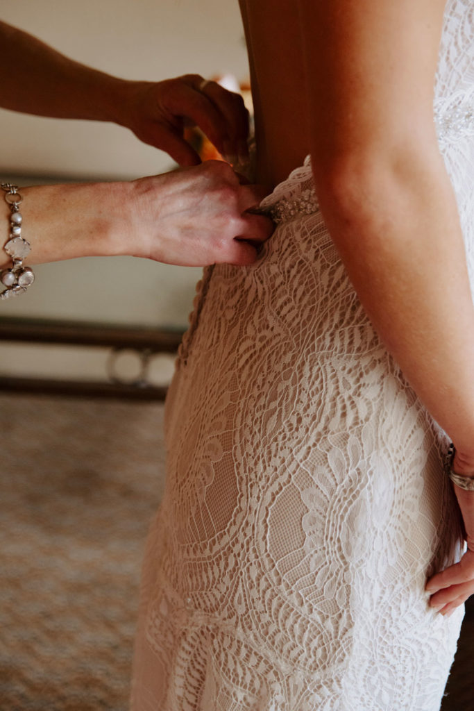 Final Touches on Bride's Dress Before Wedding