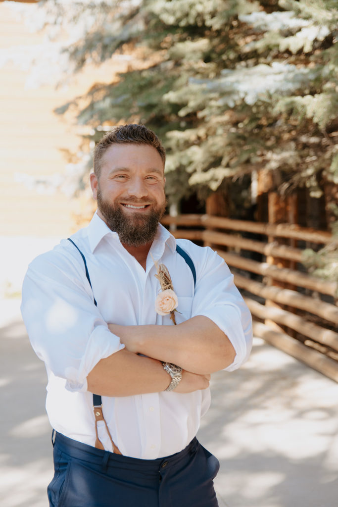Groom smiling during wedding photos at The Lodge in Jackson Hole