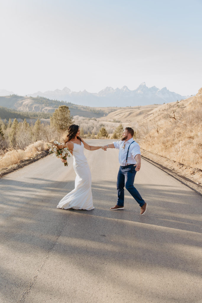 Bride and groom dancing during elopement in front of tetons