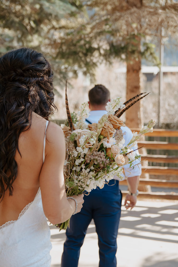 Bride walks up to groom for their first look photos at the Lodge in Jackson Hole