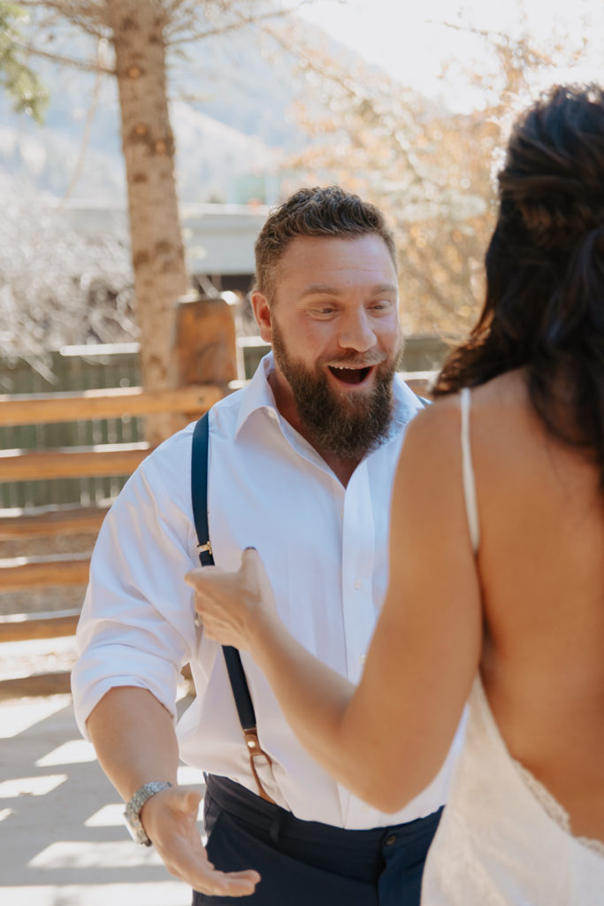Groom is excited to see his bride during their first look photos at the lodge in Jackson Hole, Wyoming