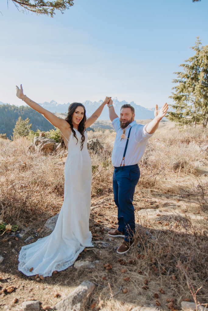Couple cheering after getting married at the wedding tree in Jackson Hole, Wy