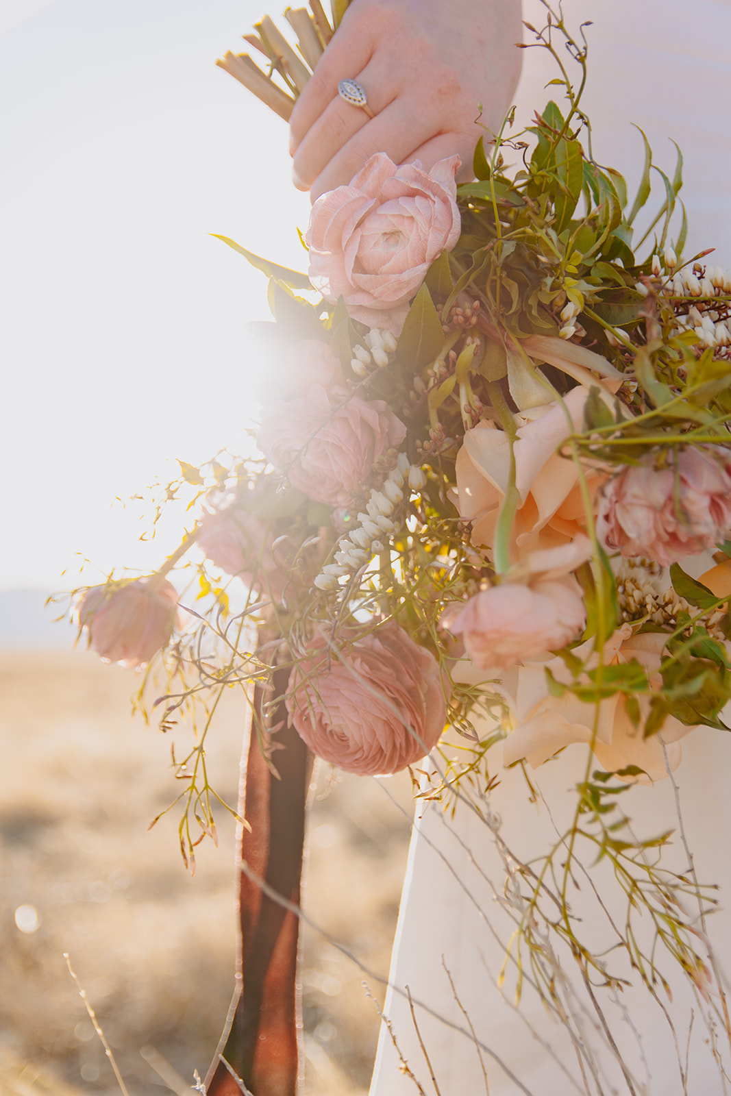 Bride holds bridal bouquet from a foxtails wyoming elopement package