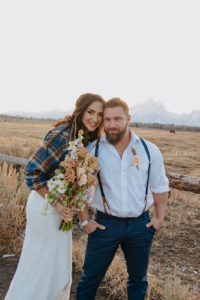 Couple standing in front of Tetons during their Wyoming elopement package with Foxtails Photography