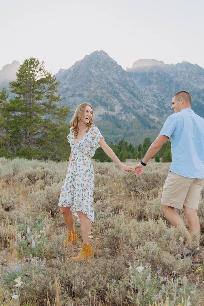 Gorgeous, dim lit engagement photo with Ariane and Jackson with Grand Teton Mountains in the background