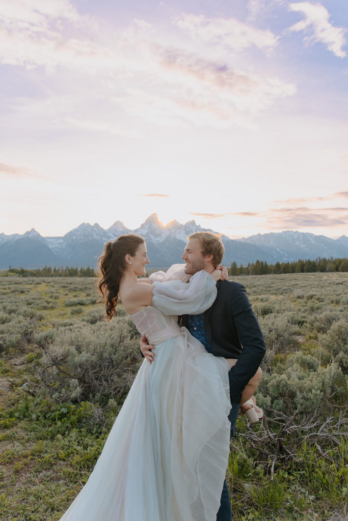 Adventure couple has fun in sage field after getting married in Jackson Hole, Wyoming