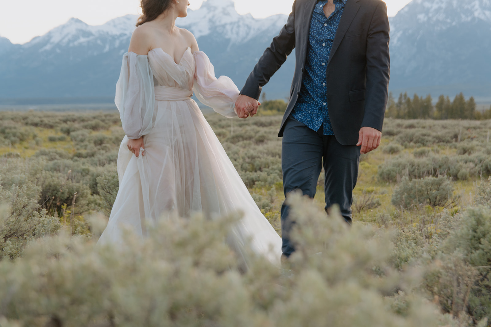 couple holds hands after getting married in Jackson Hole, Wyoming