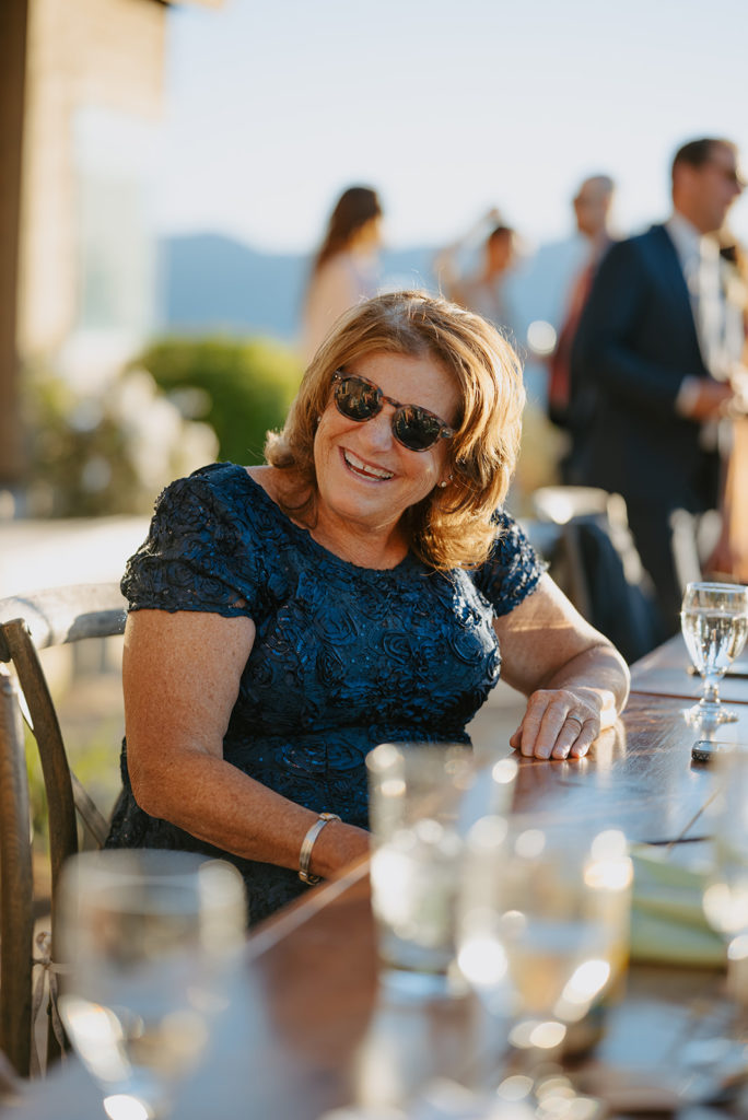 Brides mom laughs during wedding reception in Jackson Hole, Wyoming during a wedding at Spring Creek Ranch. A Jackson Hole Wedding venue