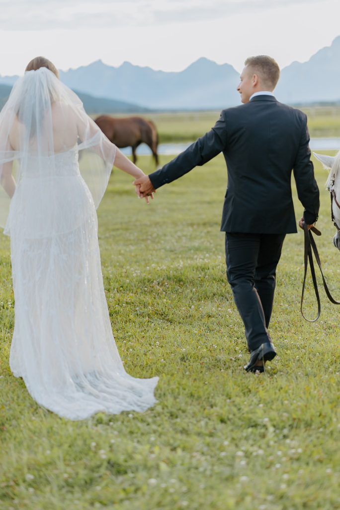 Bride and groom walk off into the ranch at Diamond Cross. 