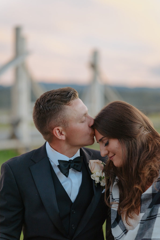 Forehead kisses between bride and groom. 