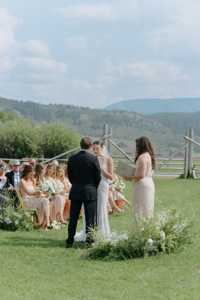 Couple saying vows during their Diamond Cross Ranch Wedding