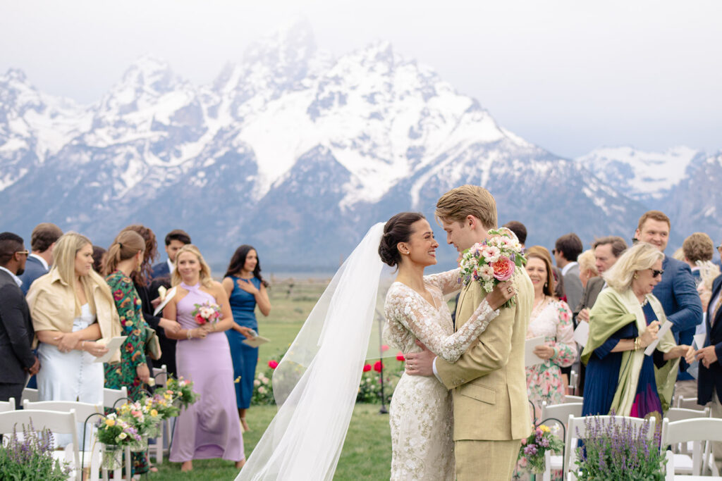 Couple laughs while walking down the aisle after getting married at Lost Creek Ranch in Jackson hole, Wyoming 
