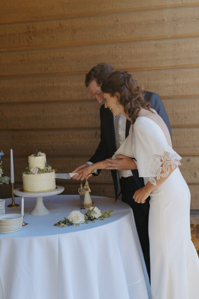 Couple cuts cake after getting married in Jackson Hole, Wyoming